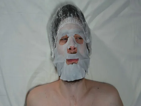 Bearded man in a spa with a mask on his face Stock Footage 128705668