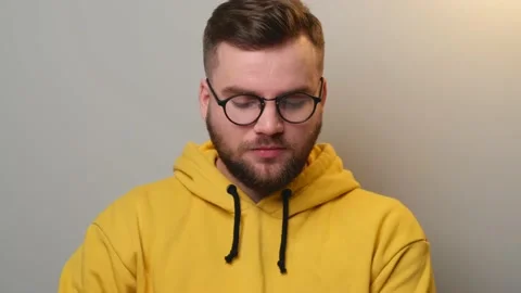 Bearded man is speaking at camera during an online lesson wearing glasses and Stock Footage 146058814