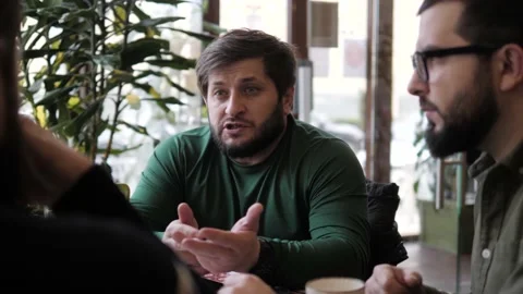 Bearded man spends time with friends in restaurant Stock Footage 145335563