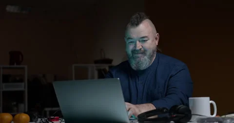 Bearded man spitefully typing on a laptop. Stock Footage 145742212