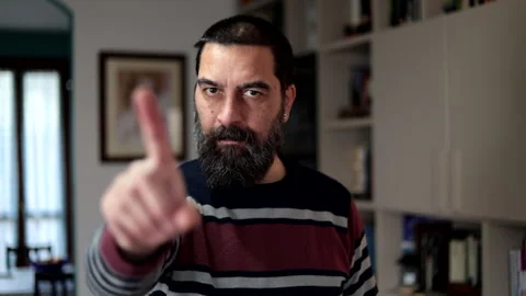 Bearded man standing with serious expression saying no with finger at home. Stock Footage 266302778