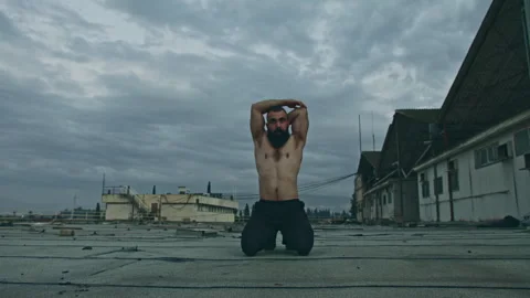 A bearded Man stretches outside Stock Footage 275593748