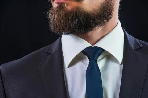Bearded man in suit on black background Stock Photos
