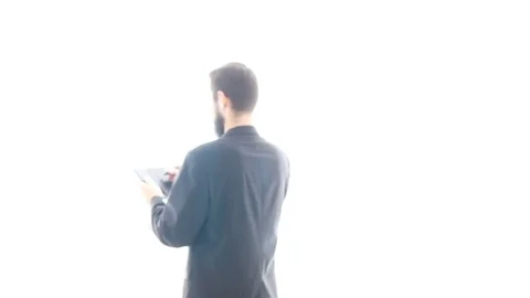 Bearded man in suit using a drawing tablet 库存影片 71610443
