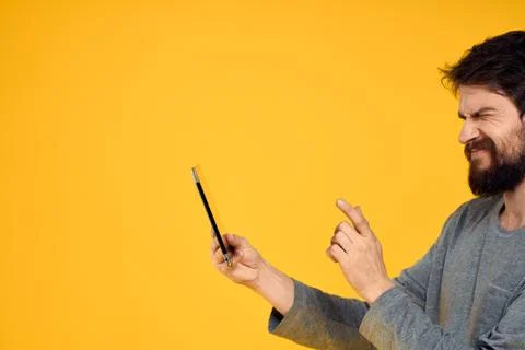 Bearded man with tablet in hands technology work wireless device yellow Stock Photos