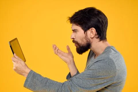Bearded man with tablet in hands technology work wireless device yellow Stock Photos