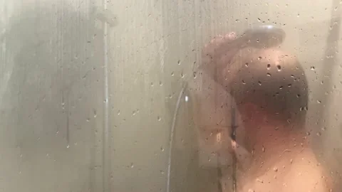 A bearded man takes a shower. Stock Footage 221923093