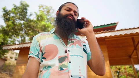 Bearded man talk on phone during scenic holiday break Stock Footage 313279668