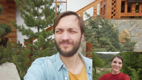 Bearded man talking by video call with cute woman using smartphone outdoor. Smal Video stock 130758324