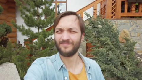 Bearded man talking by video call using smartphone outdoor. Male walking in town Video stock 130759265