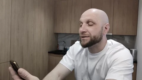 Bearded man talking via video link with his relatives from another city or Vidéo 311152187