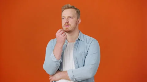 Bearded man with thoughtful expression solves problem Stock Footage 257143286
