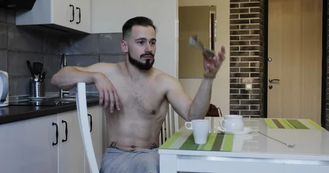 A bearded man throws a jigger while sitting at a table n. Stock Footage 118774138