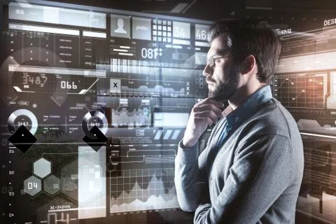 Bearded man touching his face while thoughtfully looking at the screen Foto stock