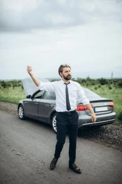 Bearded man trying to stop another driver to help with car Stock Photos
