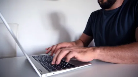 Bearded man typing on laptop Stock Footage 112931724