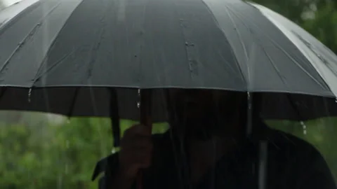 Bearded man with umbrella shows class in torrential rain Stock Footage 109550891