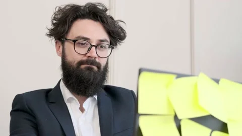 Bearded man in underwear and jacket working remote, typing at computer. Stock Footage 168976006