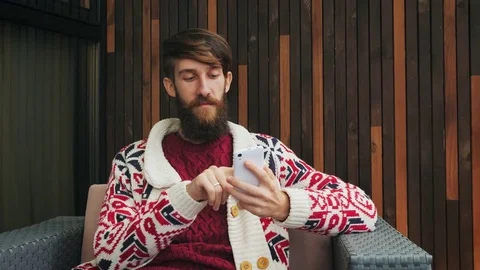 Bearded man uses a phone Stock Footage 80548894