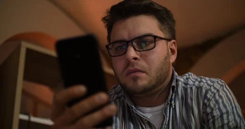 A bearded man uses a smartphone and receives an incoming call Stock Footage 87322861