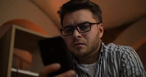 A bearded man uses a smartphone and receives an incoming call2 Stock Footage 87322930