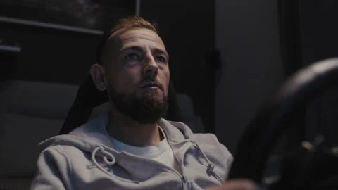 A bearded man using a driving simulator Stock Footage 258390591