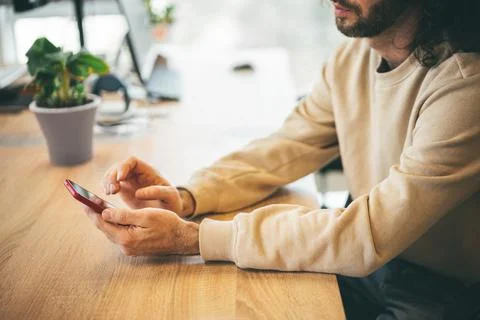 Bearded man using mobile phone in the office Stock Photos