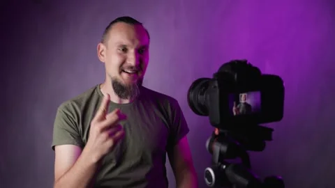 Bearded man vlogger talking in front of camera Stock Footage 156556116