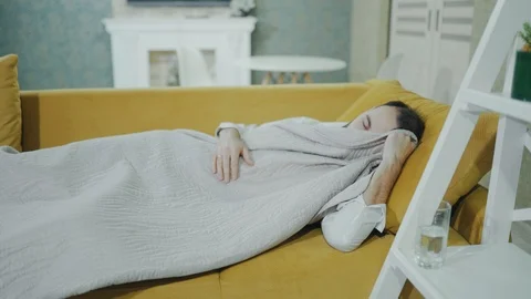 A bearded man wakes up after a night out, feels dizzy, hangover, splitting Stock Footage 99800897