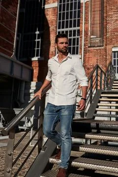 Bearded man walking on steps Stock Photos