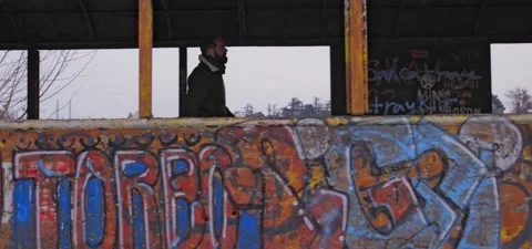 Bearded man walks through old graffiti train Stock Footage 140626526