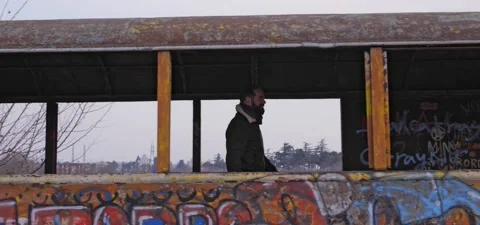 Bearded man walks through old graffiti train Stock Footage 140626587