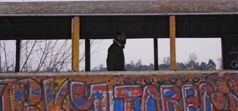 Bearded man walks through old graffiti train Stock Footage 140626606