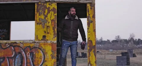 Bearded man walks through old graffiti train Stock Footage 140626611