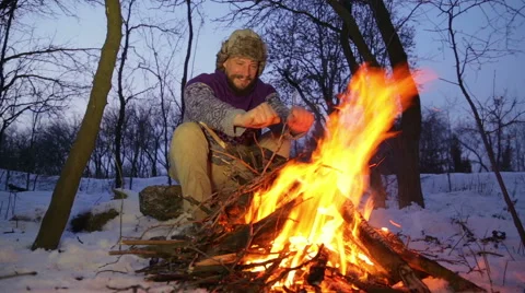 Bearded man warming his hands by the fire in winter. Stock Footage 59757146