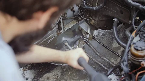 A bearded man washes the inside of the machine. Stock Footage 78701033