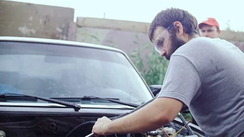 A bearded man washes the inside of the machine. Stock Footage 78701386