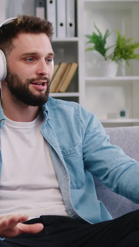 Bearded man wear headset talking by video call, involved at stream online commun Stock Footage 325448104