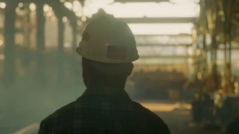 Bearded man wearing a hard hat walking around looking at his work site Stock Footage 139021207