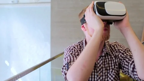 A bearded man wearing virtual reality glasses in the cafe Stock-Footage 74443547