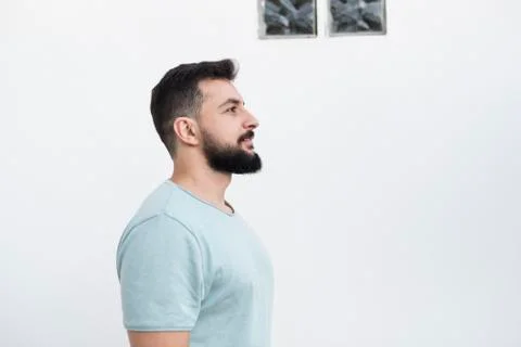 Bearded man with white wall background, outdoors shot Stock Photos