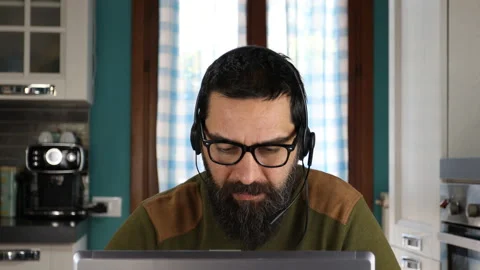 Bearded man working on computer and talking on video call. Stock Footage 152449937