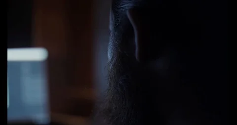 Bearded man working at the computer at night closeup Stock Footage 88060472