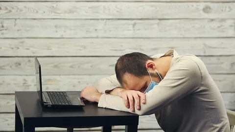 A bearded man works at the computer and coughs. Stock Footage 103487274