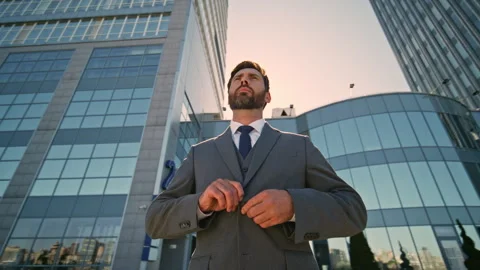 Bearded manager posing downtown buttoning elegant jacket. Handsome businessman Video stock 260358329