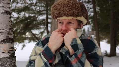 Bearded manly man trying to keep warm in winter forest Stock Footage 71796475