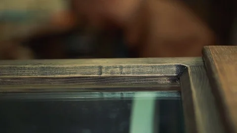 Bearded master sitting sideways in a studio and very busy with work Stock Footage 73463388