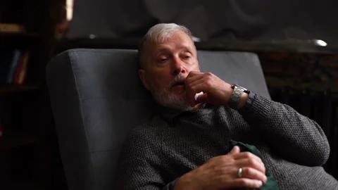 Bearded mature man lying on couch and talking about his problems with Video stock 136506279