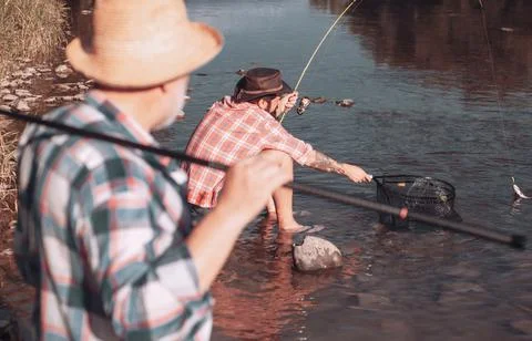 Bearded men catching fish. lear water river. Hobby sport activity. Elegant Stock Photos