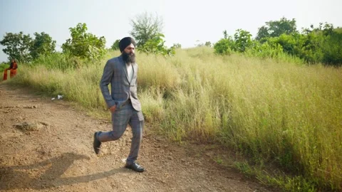 Bearded men walks by pathway side of greenery Stock Footage 296533150